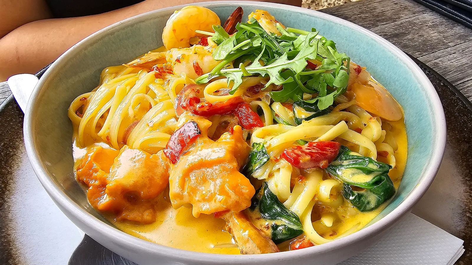 Bowl of seafood linguine with creamy sauce, cherry tomatoes and fresh rocket at Penny Lane